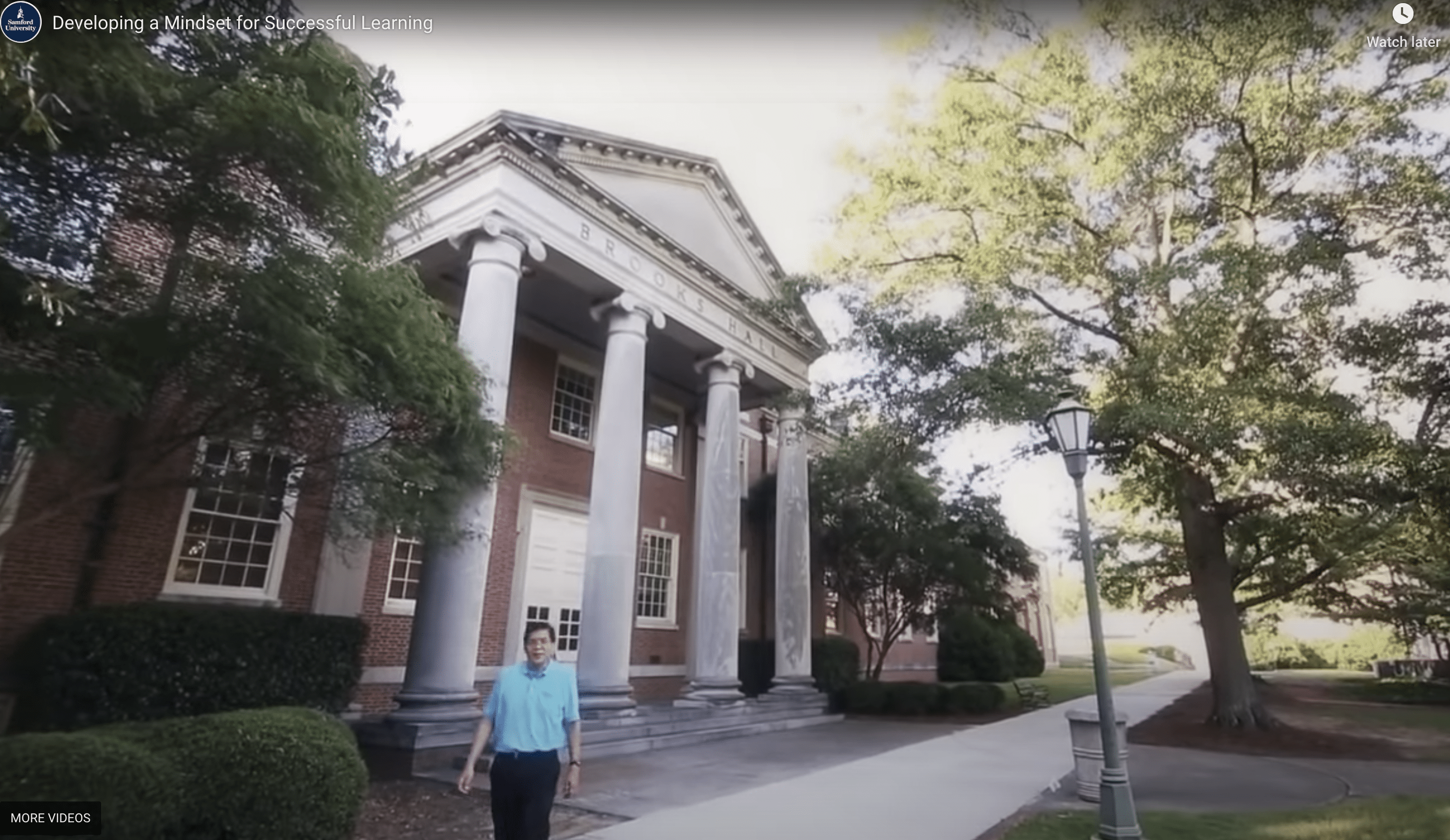 professor walking in front of university building