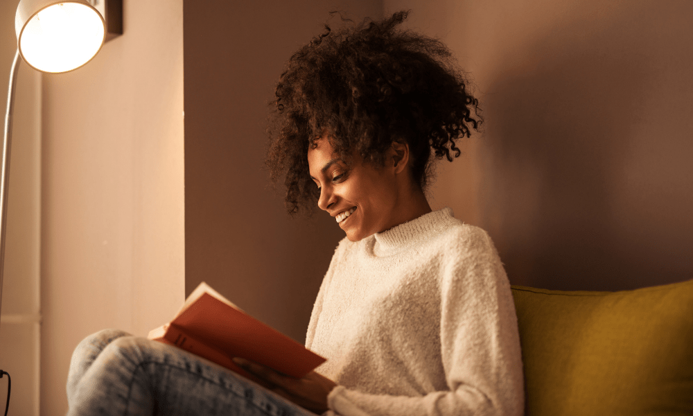 girl reading book, smiling