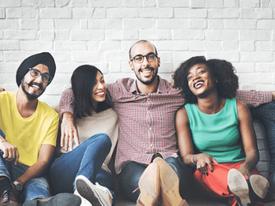 group of college students sitting together closely