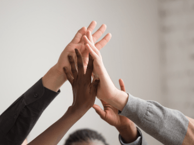 hands raised together in group high five