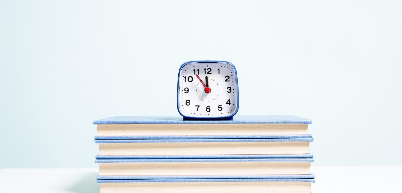 clock on pile of books