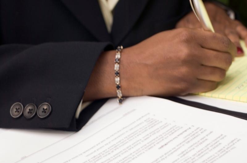 person holding pencil and writing