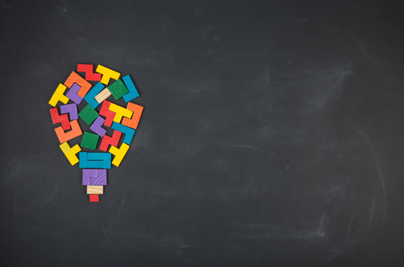 lightbulb made up of block magnets on a chalkboard to represent ideas and problem solving